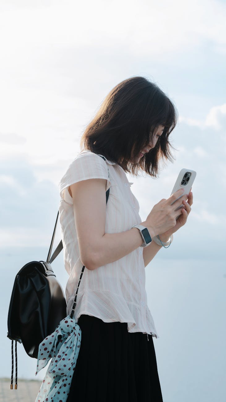 young woman using smartphone outdoors